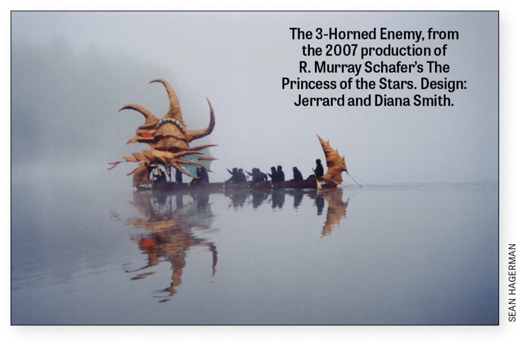 Large decorated canoe with 12 people on a misty lake